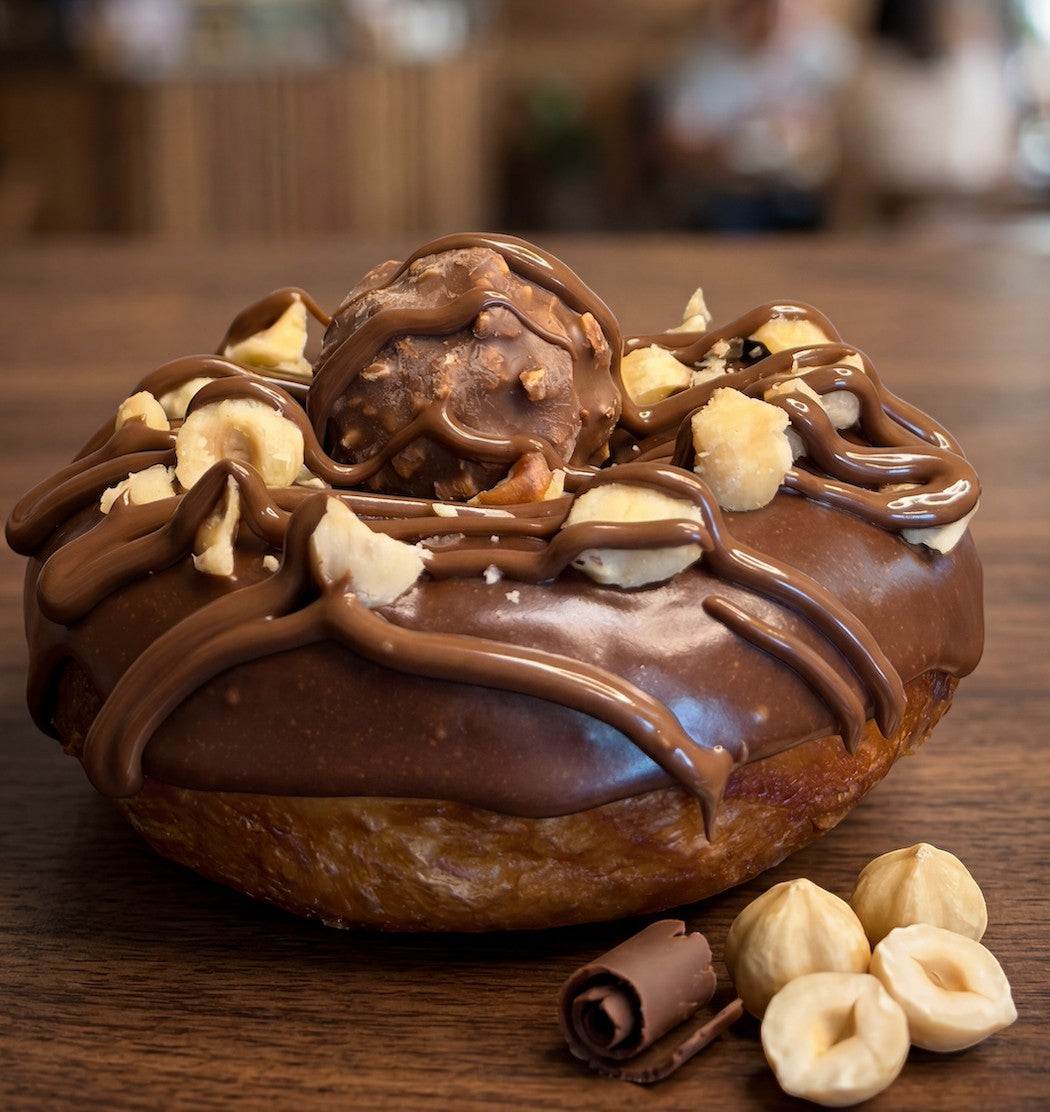 The Doughluxe Nutella Filled Donut with dark chocolate glaze, hazelnut pieces, and a Ferrero Rocher.